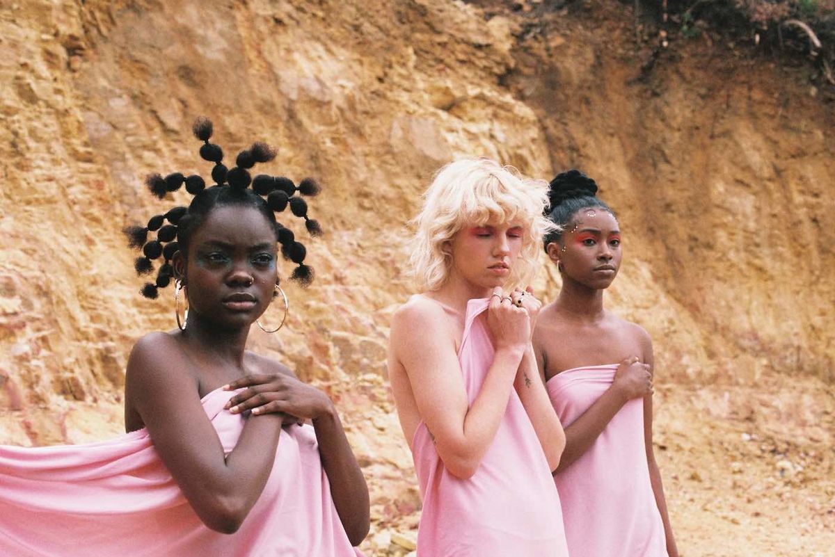 Three women all dressed in pink in a desert on-set for Sam Turpin's latest music video. 