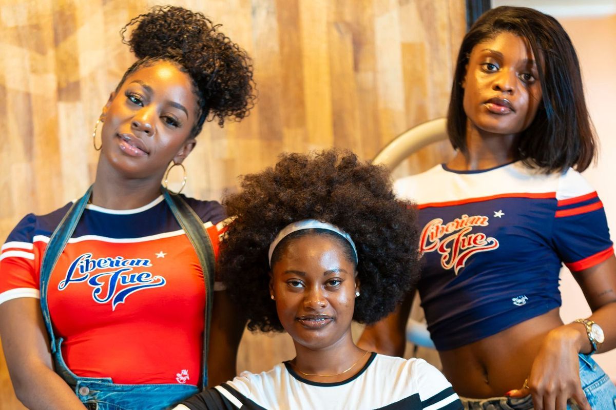 Three young ladies pose in Liberia’s leading streetwear brand - Too Easy