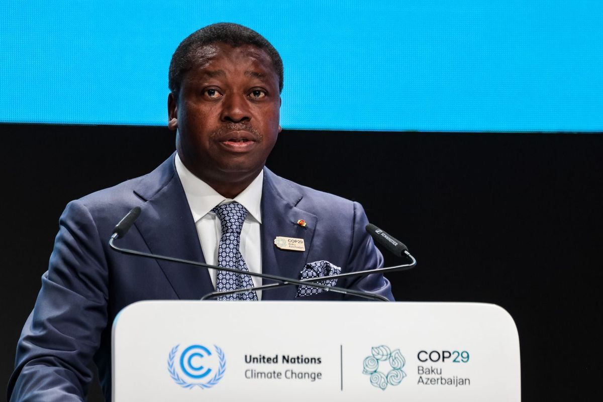 Togo President Faure Gnassingbé speaks at a podium with the United Nations COP29 signage on it.