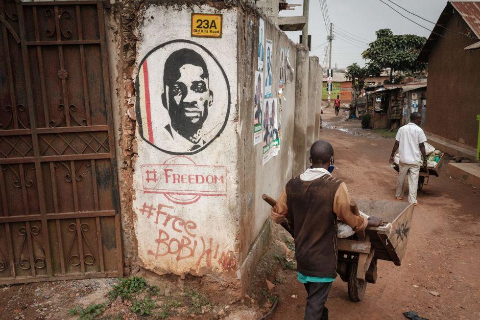 Transporters pass by graffiti supporting opposition leader Robert Kyagulanyi, also known as Bobi Wine, near the headquarters of National Unity Platform (NUP) in Kampala, Uganda, on January 18, 2021.