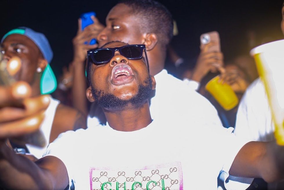 \u200bA fan sings along in the crowd at the davido concert in lagos