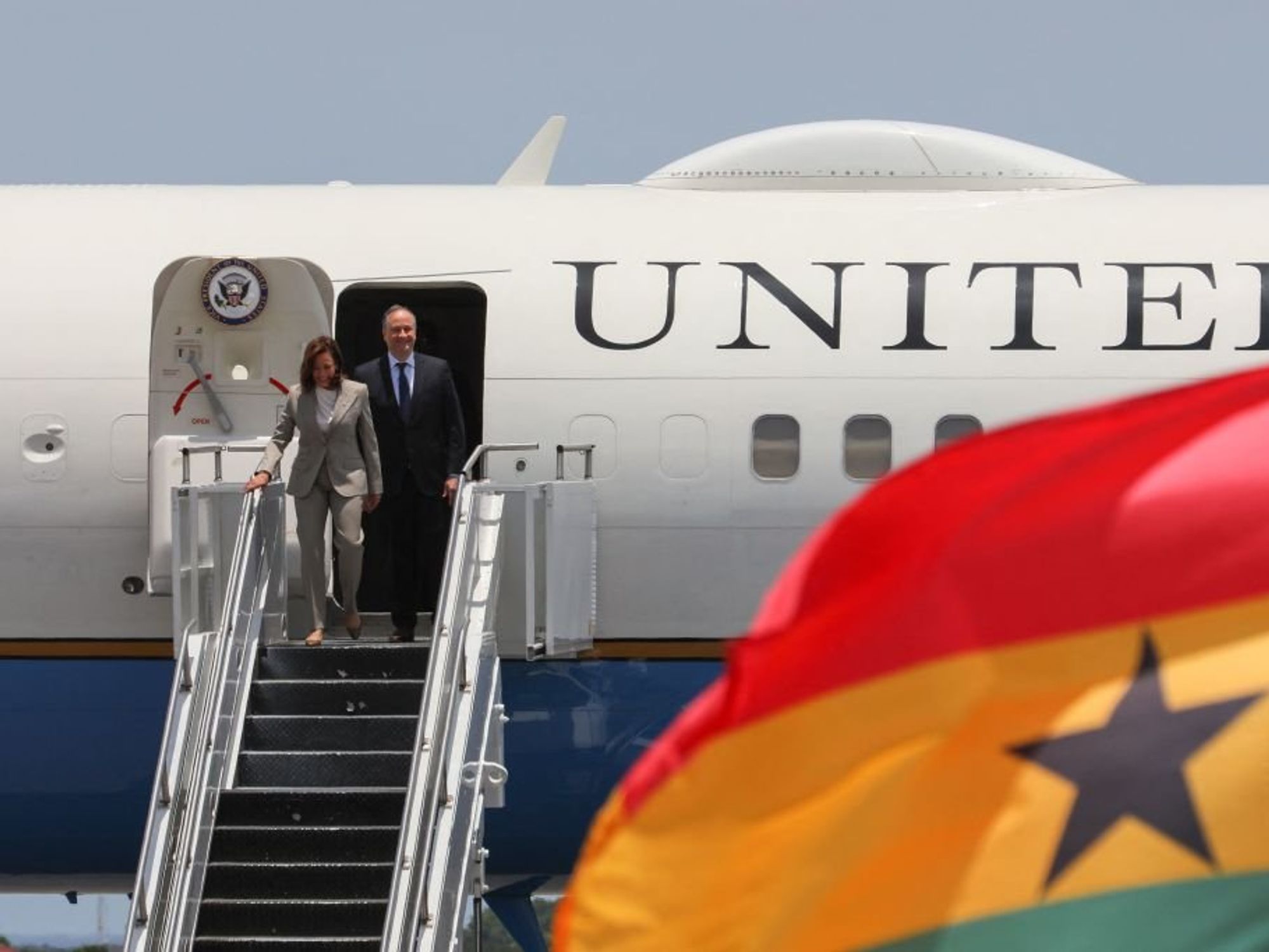 US Vice President Kamala Harris (L) and Second Gentleman of the United States Douglas Emhoff (L) disembarks the plane as they arrive at the Kotoka International Airport in Accra, Ghana.