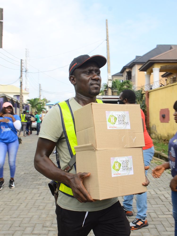​Volunteers prepare to transport packed boxes of food and other relief materials to the site for distribution for those in need at Ikotun Egbe, in Alimosho Community area of Lagos State on June 7, 2020.