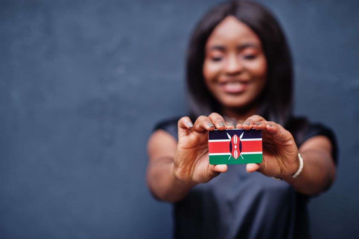 Woman holding Kenyan flag in the shape of a card