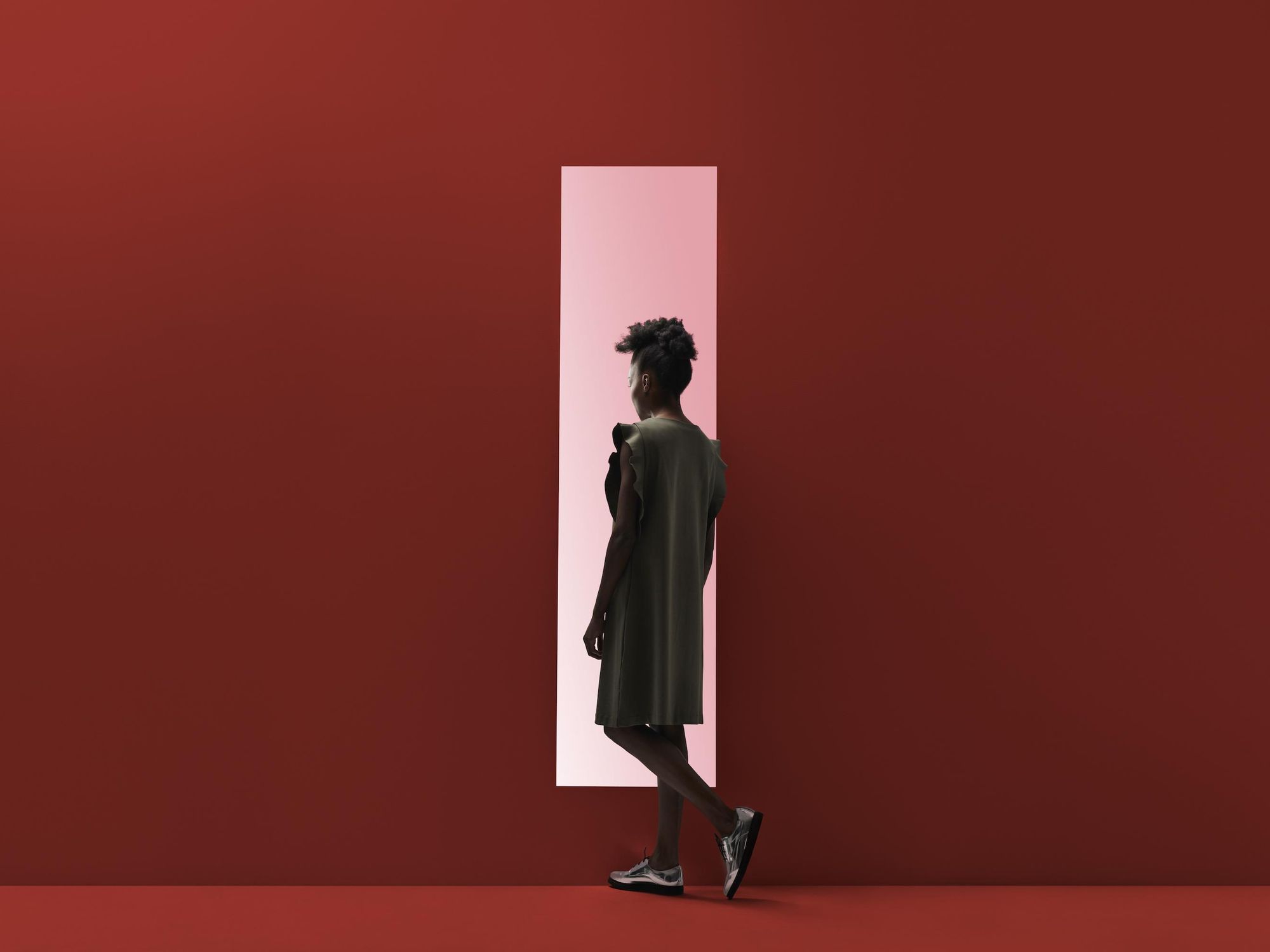 woman walking into red door