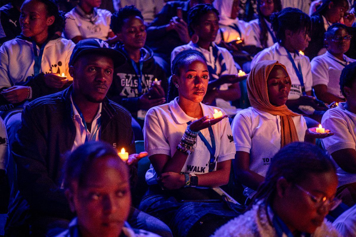Young Rwandans hold flameless candles while taking part on a vigil during the commemorations of the 30th Anniversary of the 1994 Genocide against the Tutsi at the BK Arena in Kigali on April 7, 2024. 